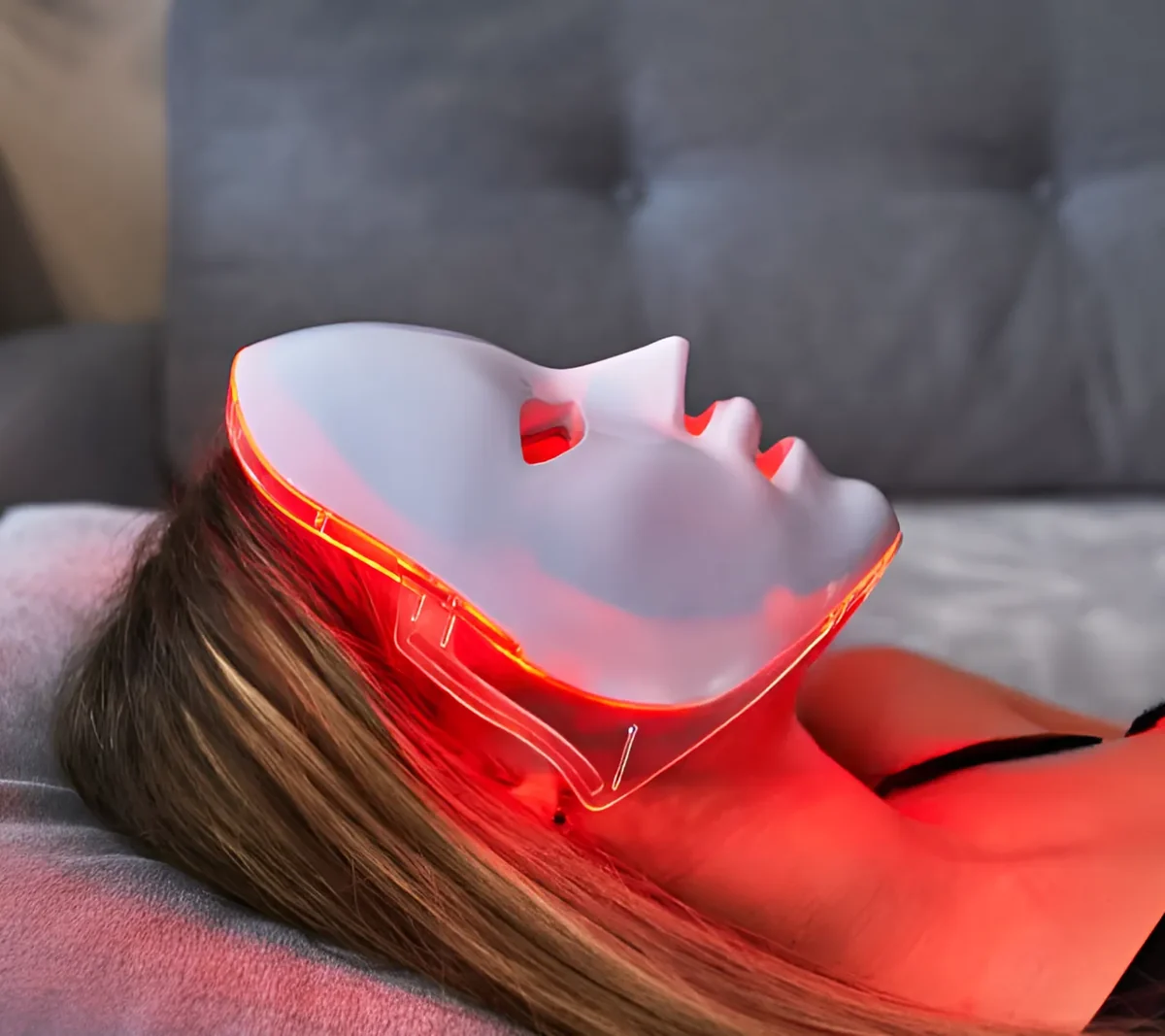 A woman relaxing with the Glokore LED mask on